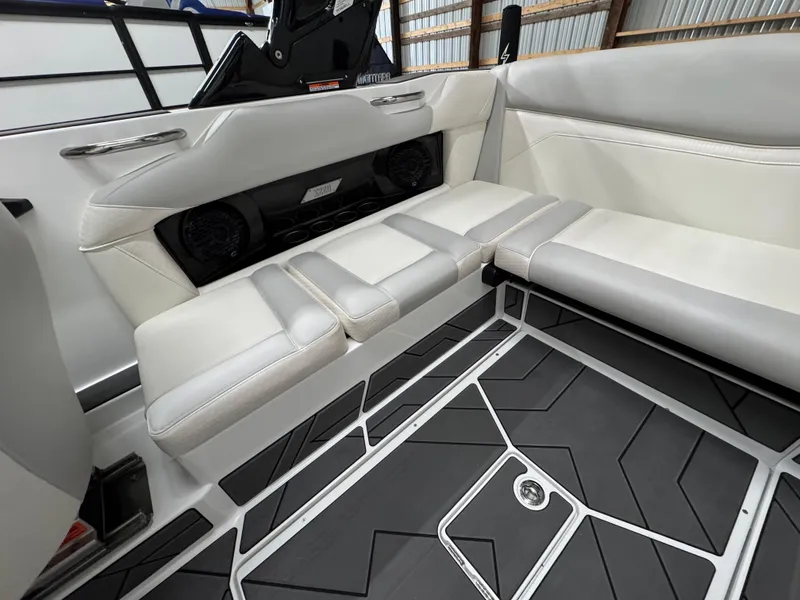 Slide: The Image of 2025 Supreme S220 boat interior with gray and white seating and modern flooring design. - 11