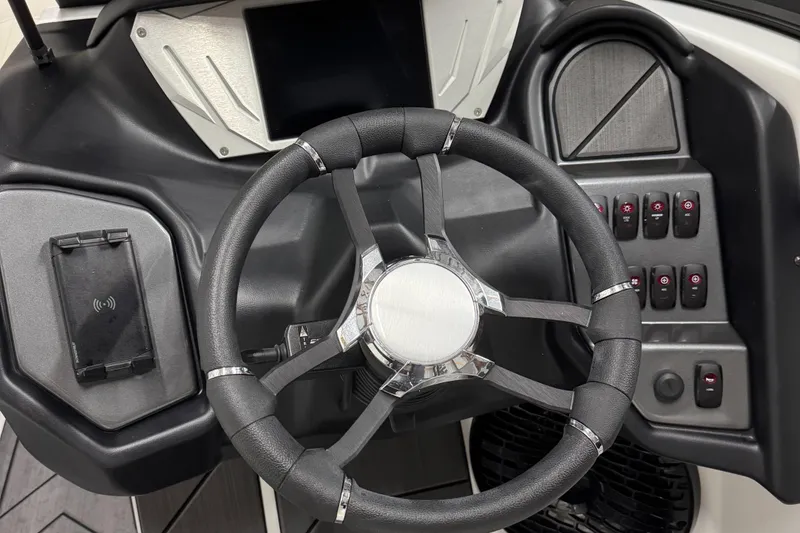 Slide: The Image of Steering wheel and dashboard of 2025 Supreme S220 boat, featuring modern controls and design. - 17