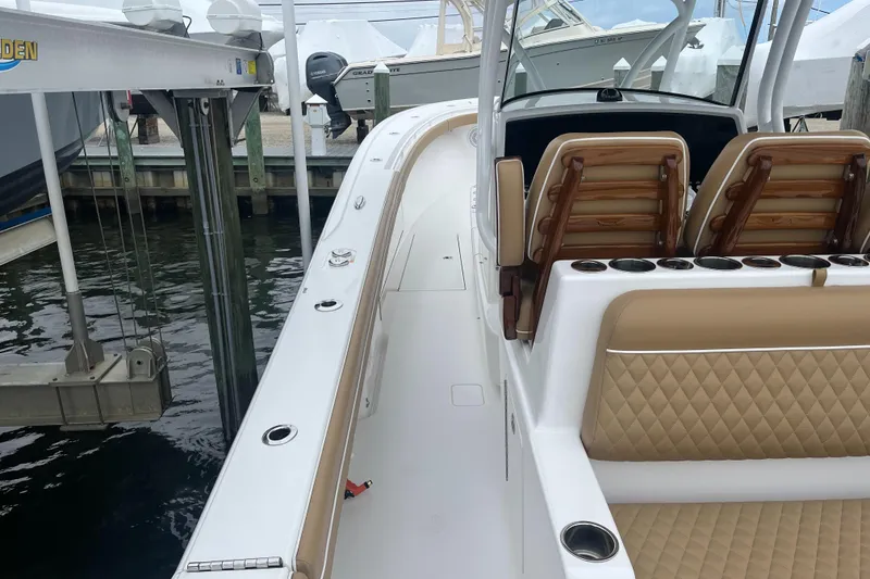 Slide: The Image of 2023 Valhalla Boatworks V-37 with tan seating, docked at marina. - 12