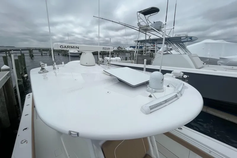 Slide: The Image of 2023 Valhalla Boatworks V-37 with Garmin equipment, docked at a marina under cloudy skies. - 17
