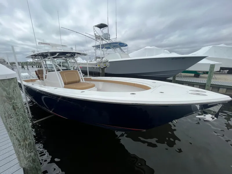 Slide: The Image of 2023 Valhalla Boatworks V-37 docked, featuring sleek design and spacious deck. - 2