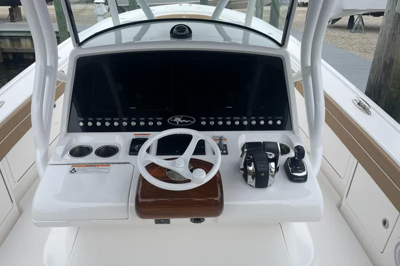 Slide: The Image of 2023 Valhalla Boatworks V-37 helm with steering wheel, controls, and navigation screens. - 5