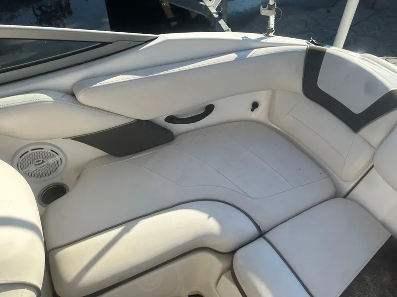 Slide: The Image of 2013 Yamaha Boats SX192 interior seating with white upholstery and speaker. - 14