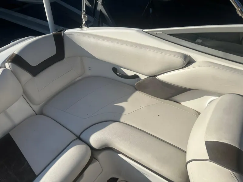 Slide: The Image of 2013 Yamaha Boats SX192 interior seating, white and gray upholstery. - 15