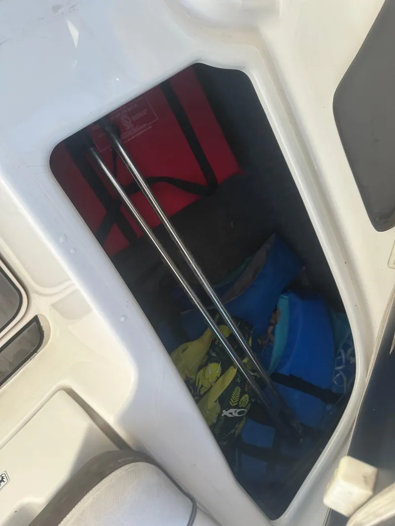 Slide: The Image of Storage compartment in a 2013 Yamaha SX192 boat with life jackets and equipment. - 19