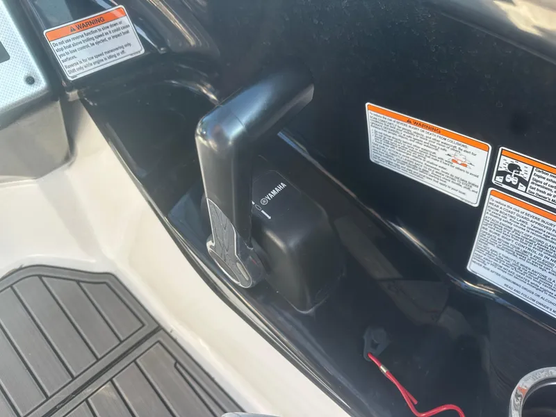 Slide: The Image of Close-up of 2013 Yamaha SX192 boat throttle control with safety warnings. - 24
