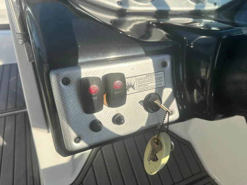 Slide: The Image of Control panel of 2013 Yamaha SX192 boat with ignition key and switches. - 25