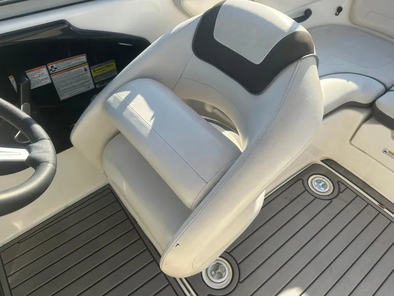 Slide: The Image of 2013 Yamaha SX192 boat interior with white captain's chair and gray flooring. - 27