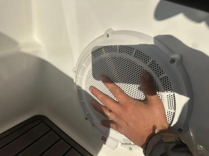 Slide: The Image of Hand touching speaker on 2013 Yamaha SX192 boat interior. - 31