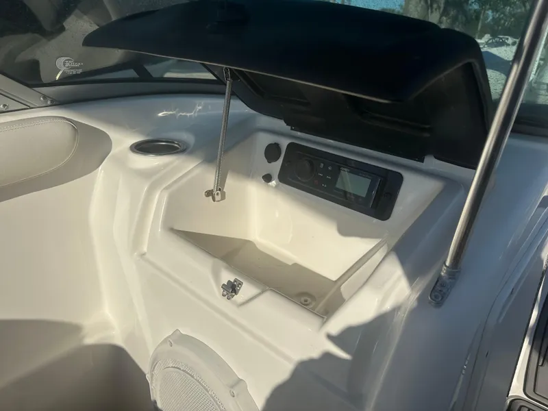 Slide: The Image of 2013 Yamaha SX192 boat dashboard with open storage compartment and audio system. - 32