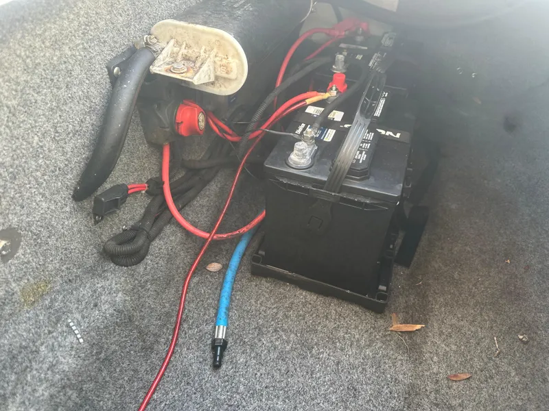 Slide: The Image of Battery compartment of 2013 Yamaha Boats SX192 with wiring and tools. - 42