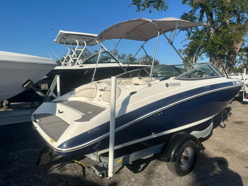 Slide: The Image of 2013 Yamaha SX192 boat on trailer, parked outdoors under clear sky. - 5