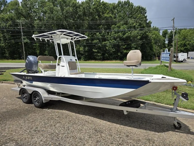 The Image of 2025 Avid 22 Recon boat on trailer, parked outdoors, featuring sleek design and modern features. - 1