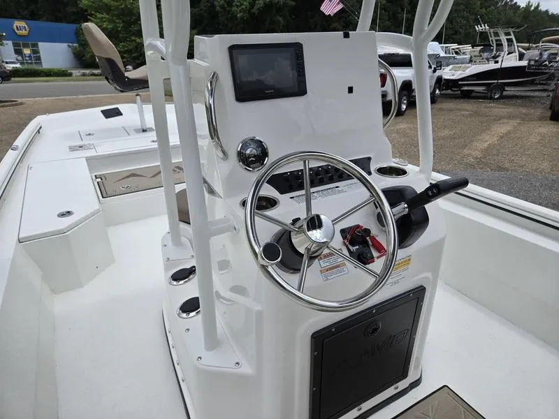 Slide: The Image of 2025 Avid 22 Recon boat console with steering wheel and navigation display. - 12