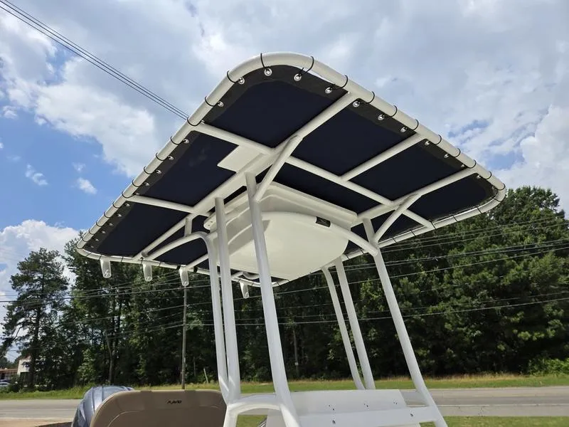 Slide: The Image of Avid 22 Recon 2025 boat T-top against a cloudy sky and trees. - 2