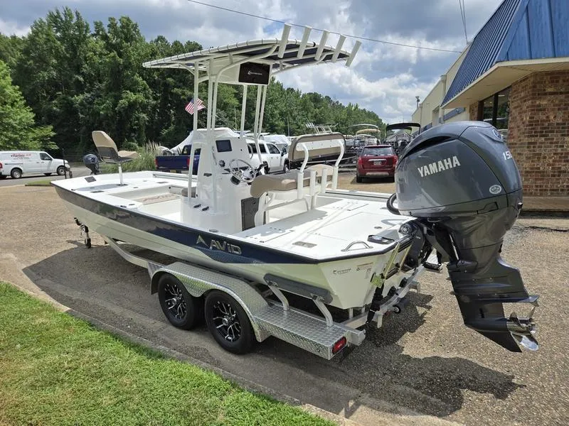 Slide: The Image of Avid 22 Recon 2025 boat with Yamaha engine on a trailer, parked outdoors. - 4