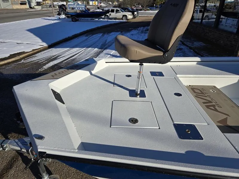 Slide: The Image of 2025 Avid 22 Recon boat deck with swivel seat, parked outdoors on a snowy day. - 9