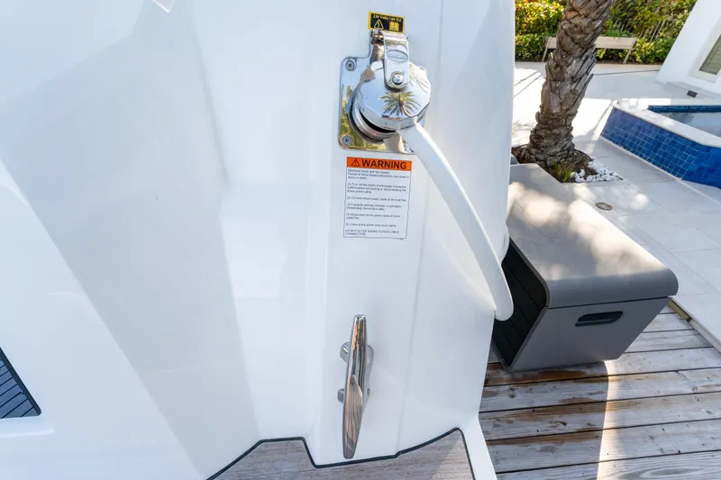 Slide: The Image of 2023 Prestige 460 Fly yacht detail with safety warning label and outdoor setting. - 10