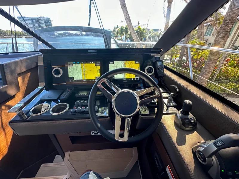 Slide: The Image of 2023 Prestige 460 Fly yacht cockpit with advanced navigation system and steering wheel. - 22