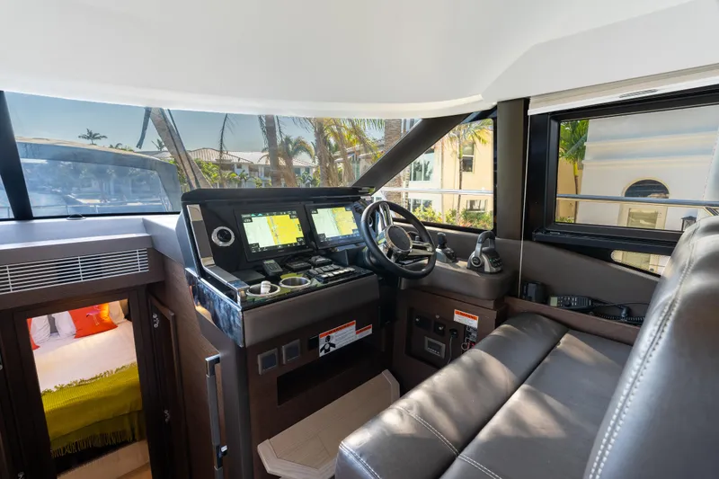 Slide: The Image of Interior cockpit of 2023 Prestige 460 Fly yacht with modern navigation equipment. - 23