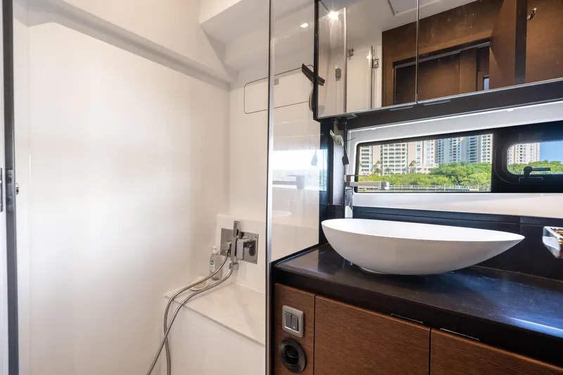 Slide: The Image of Modern bathroom interior on 2023 Prestige 460 Fly yacht, featuring sleek sink and window view. - 30