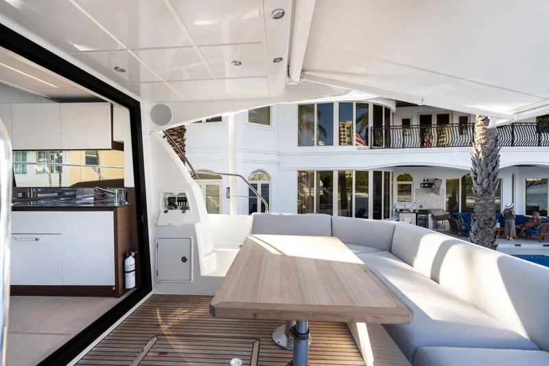 Slide: The Image of Prestige 460 Fly 2023 yacht interior with modern seating and dining area. - 8