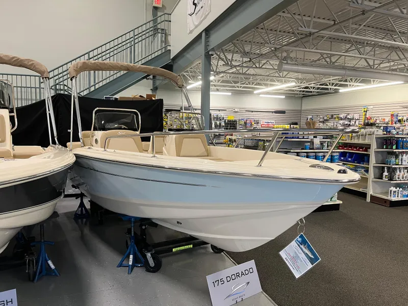 The Image of 2025 Scout 175 Sport Dorado boat displayed in a showroom. - 0