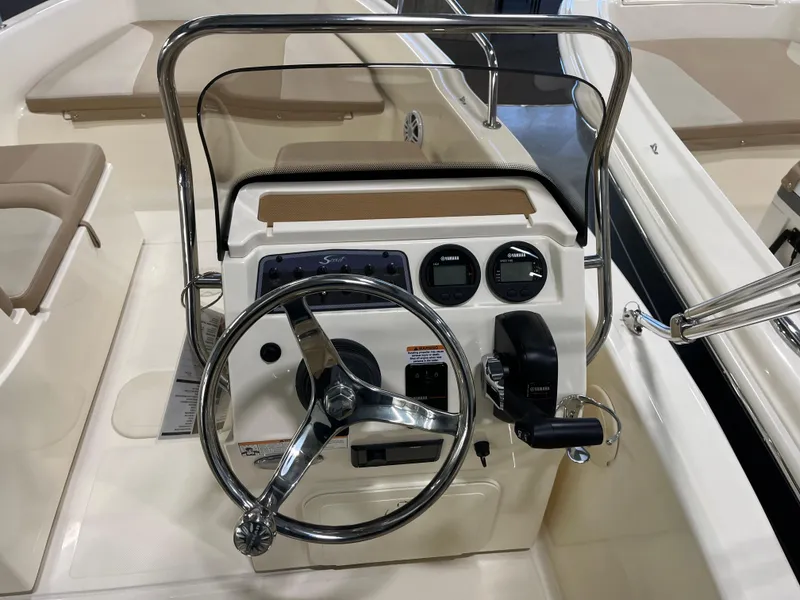 Slide: The Image of 2025 Scout 175 Sport Dorado boat dashboard with steering wheel and controls. - 5