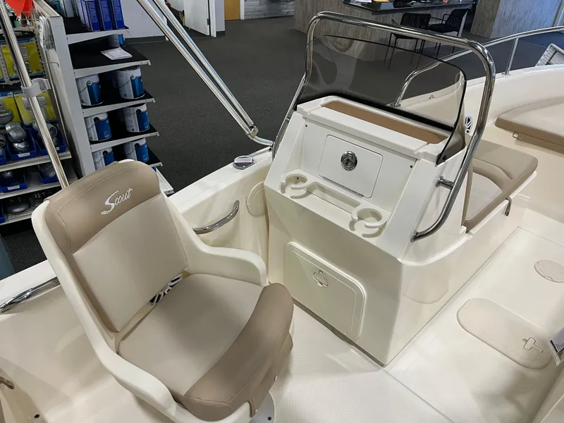 Slide: The Image of 2025 Scout 175 Sport Dorado boat interior with beige seating and console. - 6