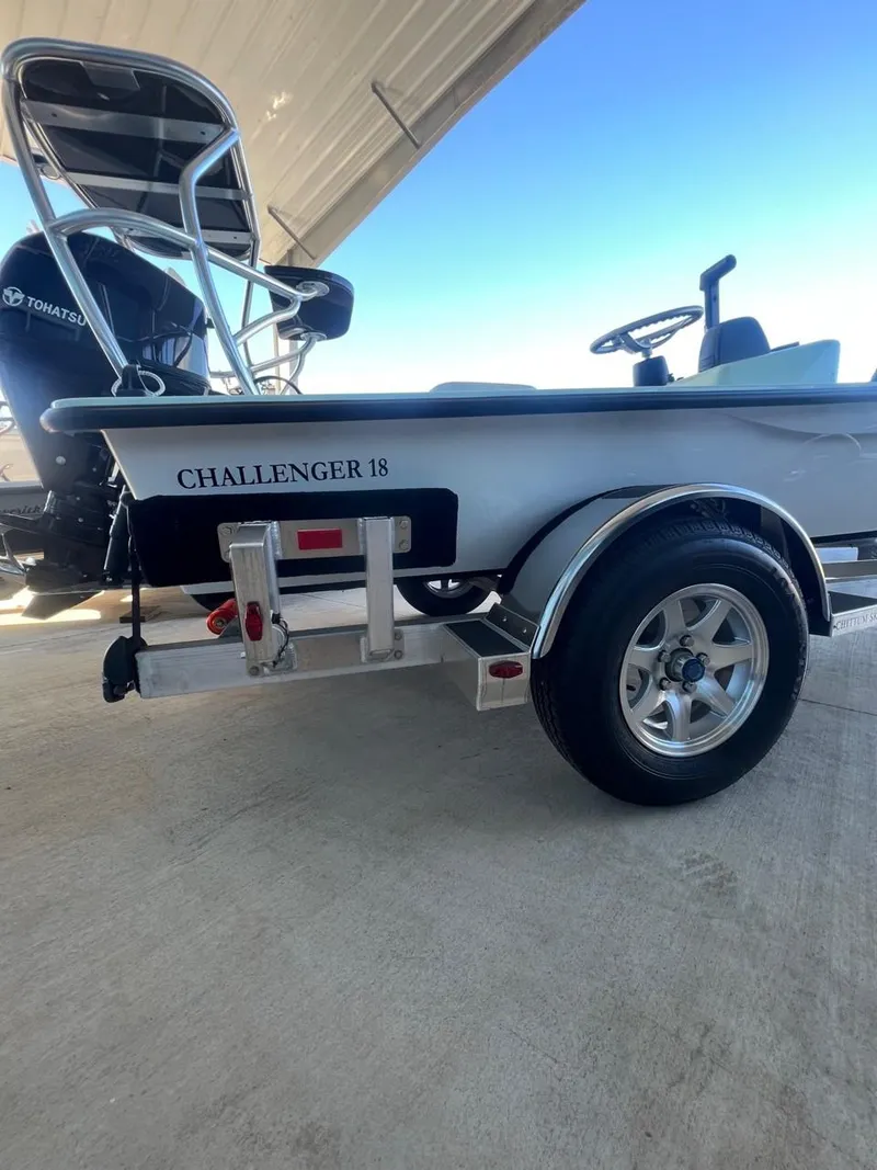 Slide: The Image of 2024 Chittum Skiffs Challenger 18 boat on trailer, side view under shelter. - 11