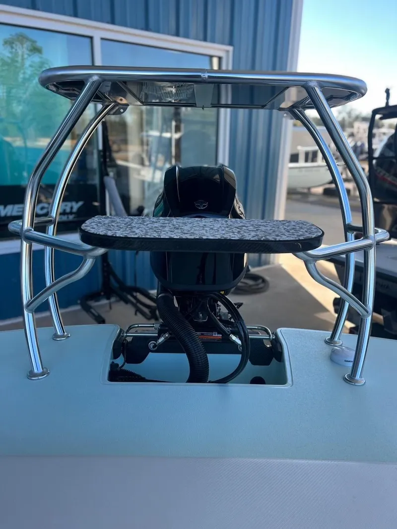 Slide: The Image of 2024 Chittum Skiffs Challenger 18 boat detail with motor and metal framework. - 13