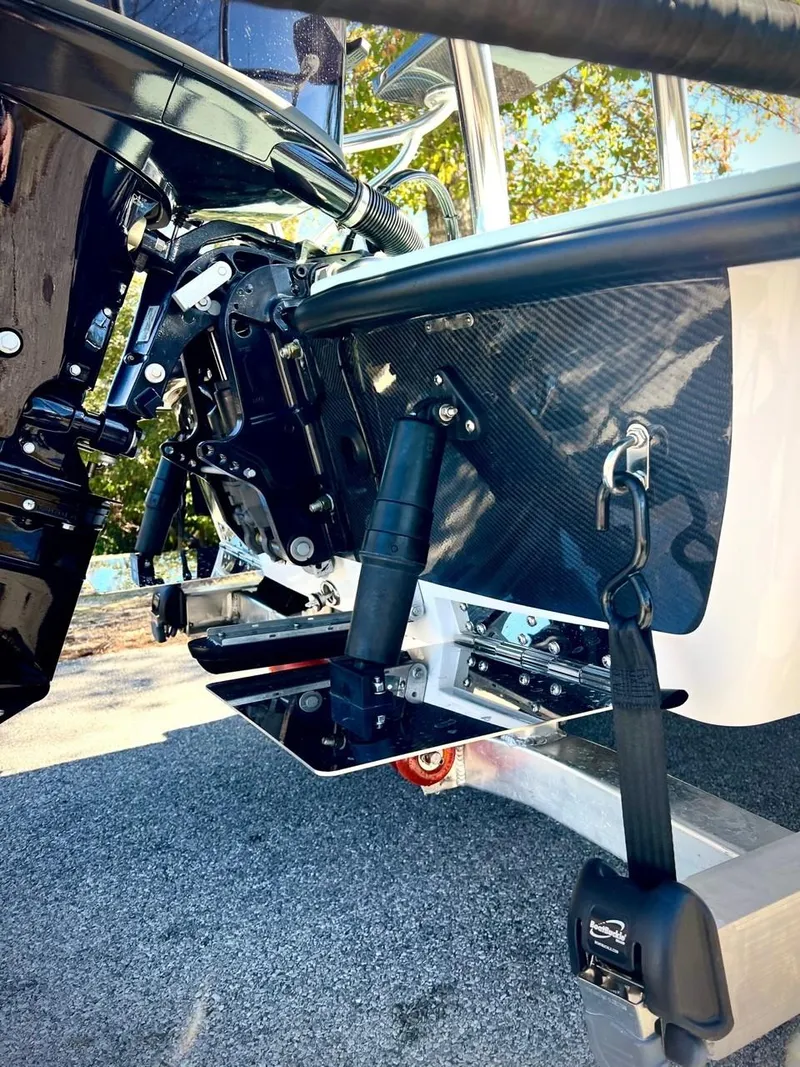 Slide: The Image of 2024 Chittum Skiffs Challenger 18 boat, detailed view of motor and hull components. - 16