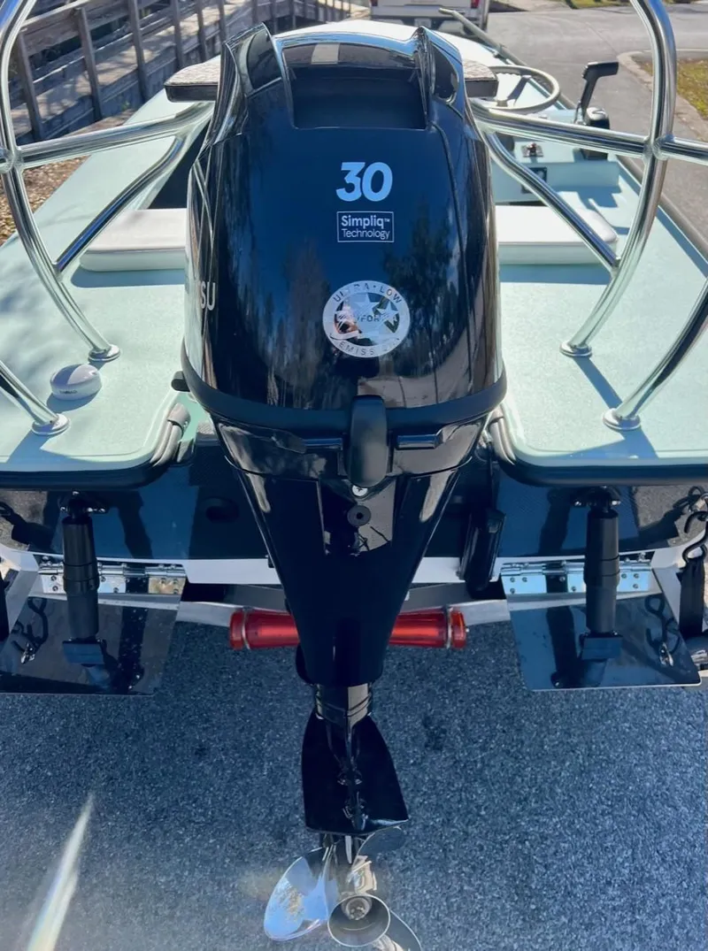 Slide: The Image of 2024 Chittum Skiffs Challenger 18 with 30 HP outboard motor, rear view. - 2