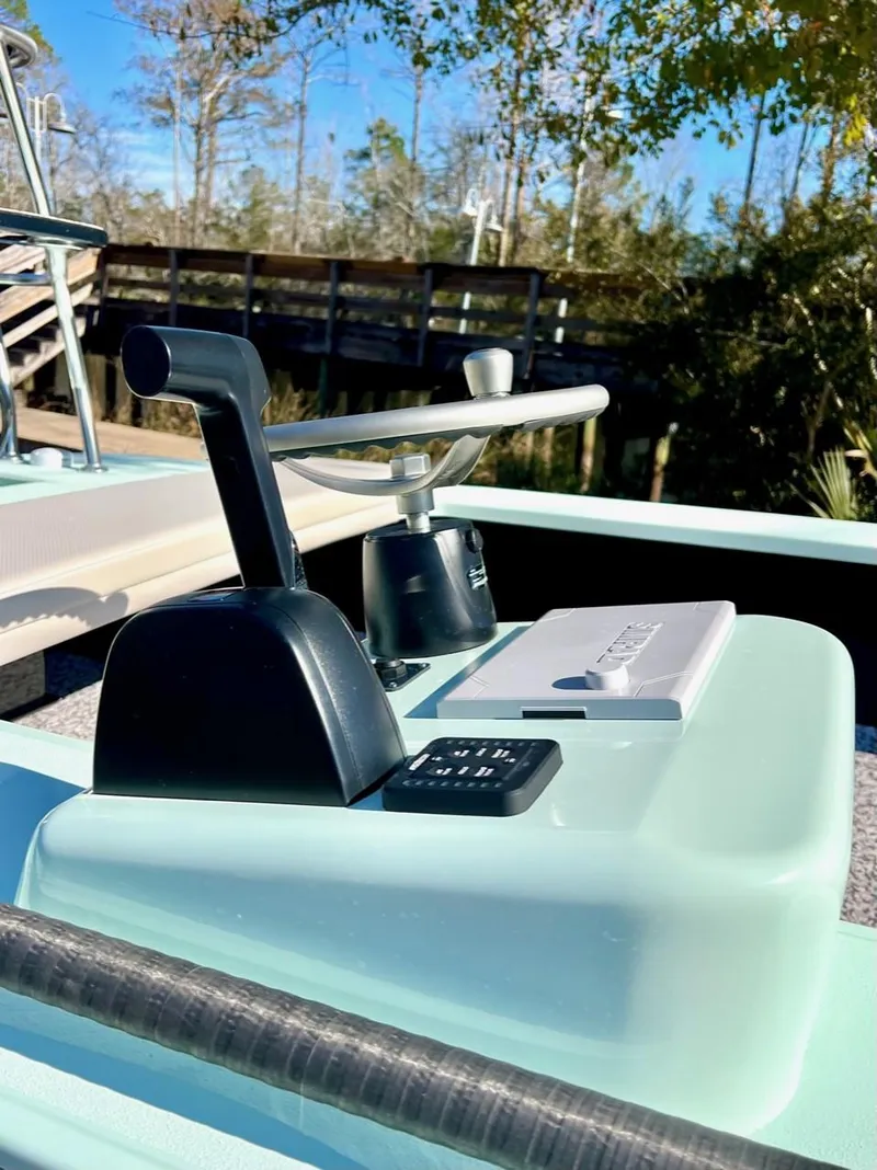 Slide: The Image of 2024 Chittum Skiffs Challenger 18 boat control panel with throttle lever, outdoors. - 3