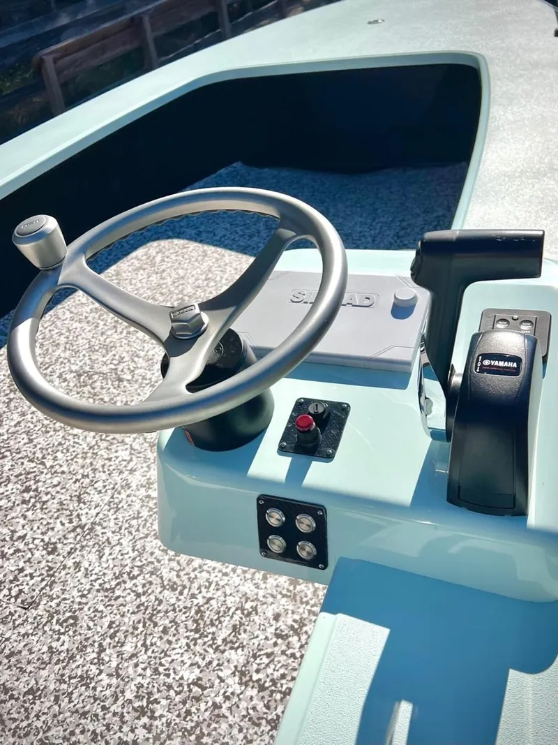 Slide: The Image of 2024 Chittum Skiffs Challenger 18 boat console with steering wheel and controls. - 4
