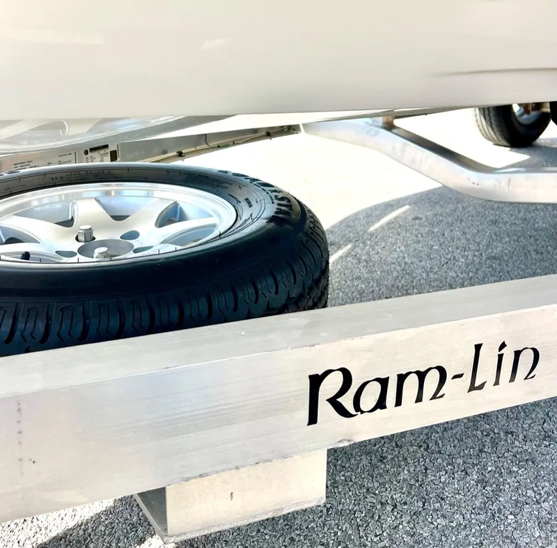 Slide: The Image of 2024 Chittum Skiffs Challenger 18 on Ram-Lin trailer, showcasing wheel and frame details. - 9