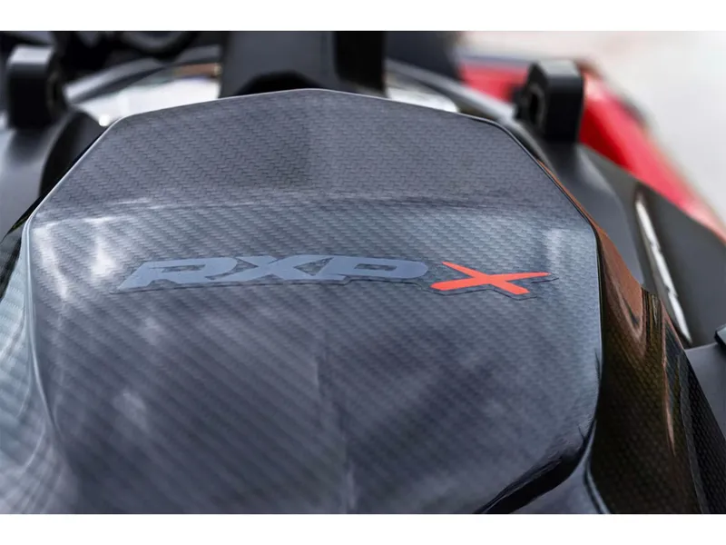 Slide: The Image of Close-up of 2025 Sea-Doo RXP-X 325 Tech Package logo on carbon fiber surface. - 7