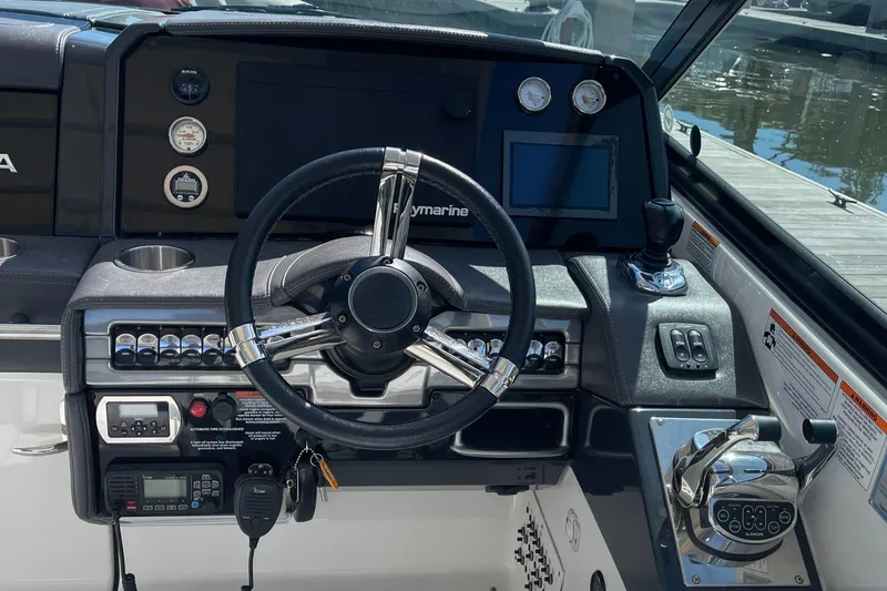 Slide: The Image of 2020 Formula 330 Crossover Bowrider helm with steering wheel and control panel. - 2