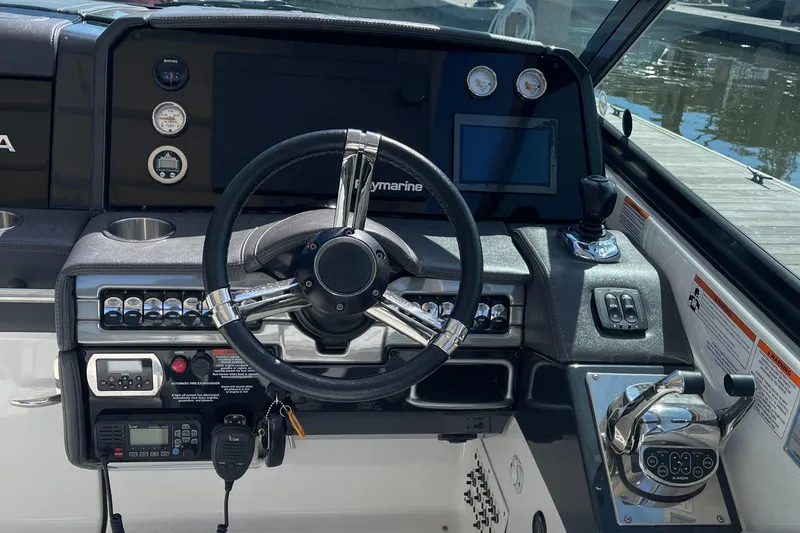Slide: The Image of 2020 Formula 330 Crossover Bowrider dashboard with steering wheel and controls. - 3