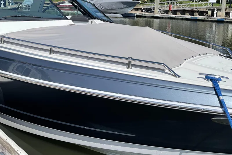 Slide: The Image of 2020 Formula 330 Crossover Bowrider docked with cover on, sleek design. - 9