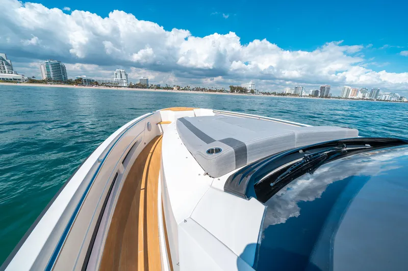 Slide: The Image of 2022 Windy SR44 SX yacht cruising near a coastal city under a blue sky. - 24