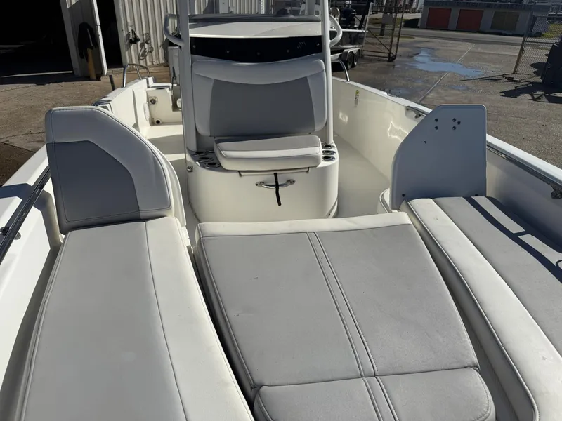 Slide: The Image of 2014 Boston Whaler 240 Dauntless boat interior with cushioned seating and console. - 11