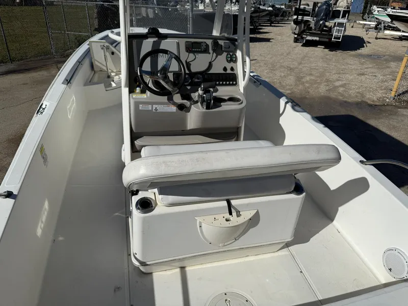 Slide: The Image of 2014 Boston Whaler 240 Dauntless boat interior with steering console and seating. - 12