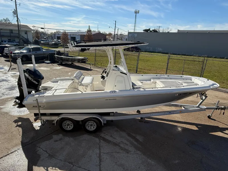 Slide: The Image of 2014 Boston Whaler 240 Dauntless boat on trailer, parked outdoors. - 2