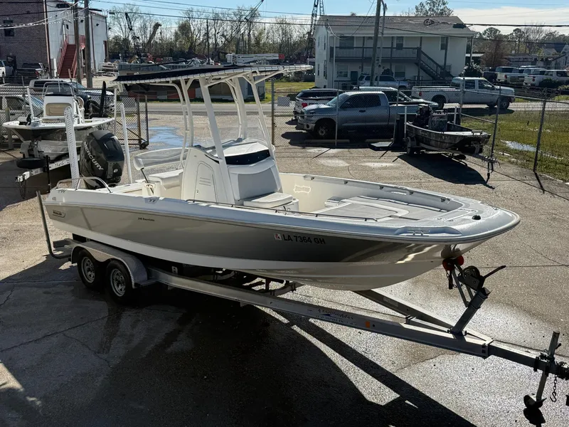 Slide: The Image of 2014 Boston Whaler 240 Dauntless boat on trailer in a parking lot. - 4