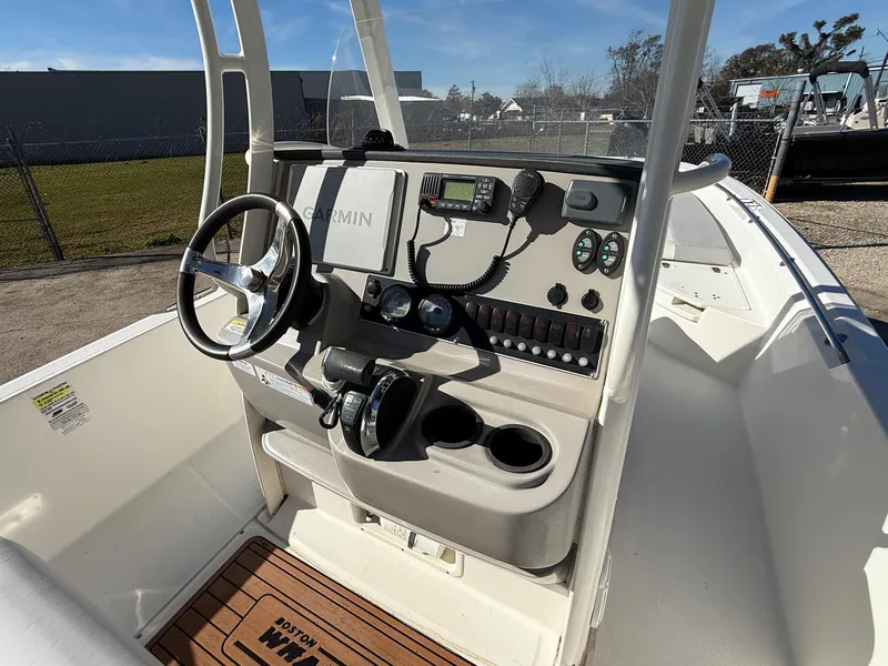 Slide: The Image of 2014 Boston Whaler 240 Dauntless boat console with steering wheel and navigation equipment. - 5