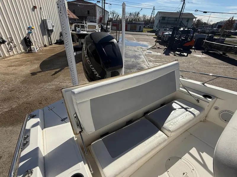 Slide: The Image of 2014 Boston Whaler 240 Dauntless boat with Mercury engine, docked outdoors. - 9