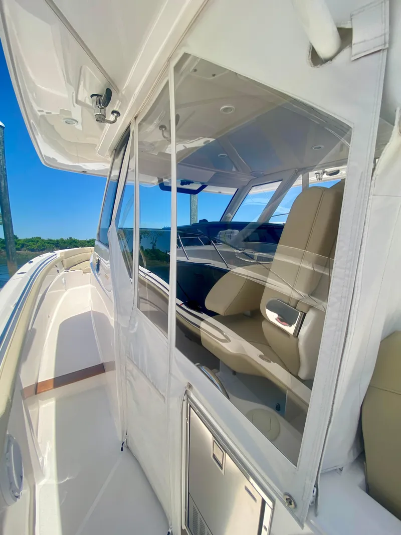 Slide: The Image of 2019 Pursuit S 408 Sport boat interior with sleek design and comfortable seating. - 16