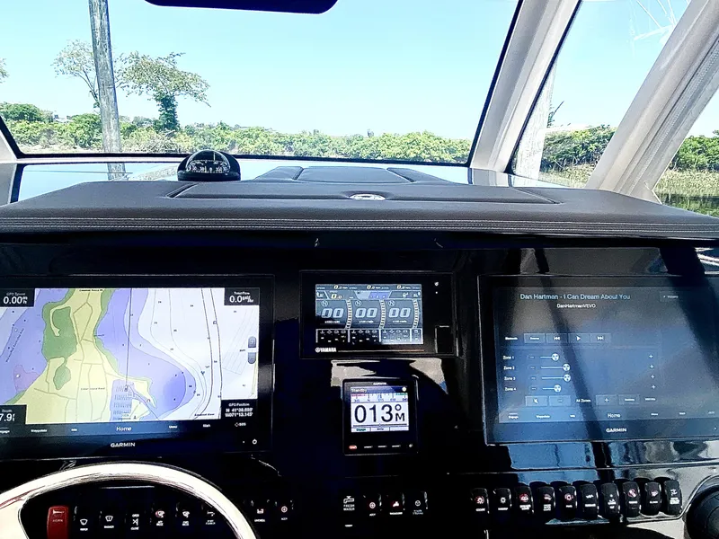 Slide: The Image of Dashboard of 2019 Pursuit S 408 Sport boat with navigation and control screens. - 19