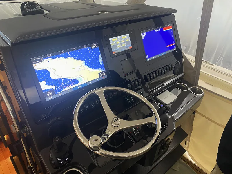 Slide: The Image of Helm of 2019 Pursuit S 408 Sport boat with navigation screens and steering wheel. - 21